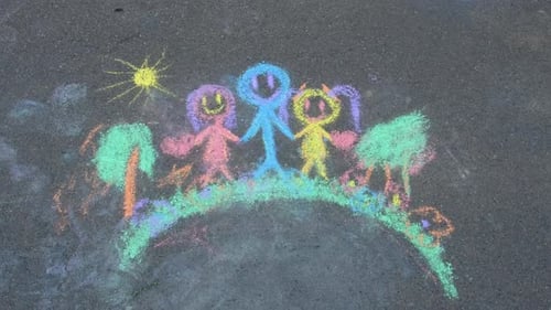 Children Drawing with Chalk on the Asphalt Selective Focus