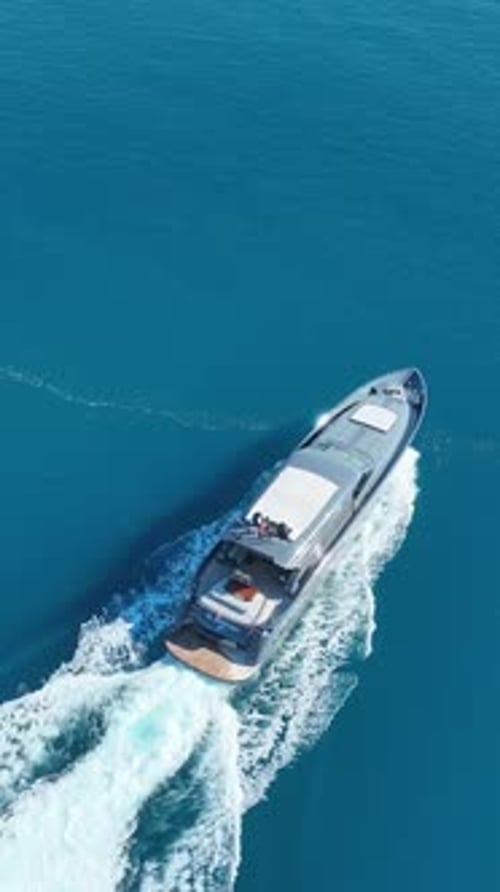 Luxury Yacht at Sea: A sleek, elegant yacht glides across the serene turquoise waters, leaving a tra