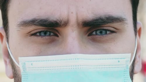 Close Up Portrait of Young Man Wearing Protective Mask