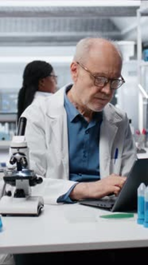Scientist Working in Lab Covering Face in Disappointment