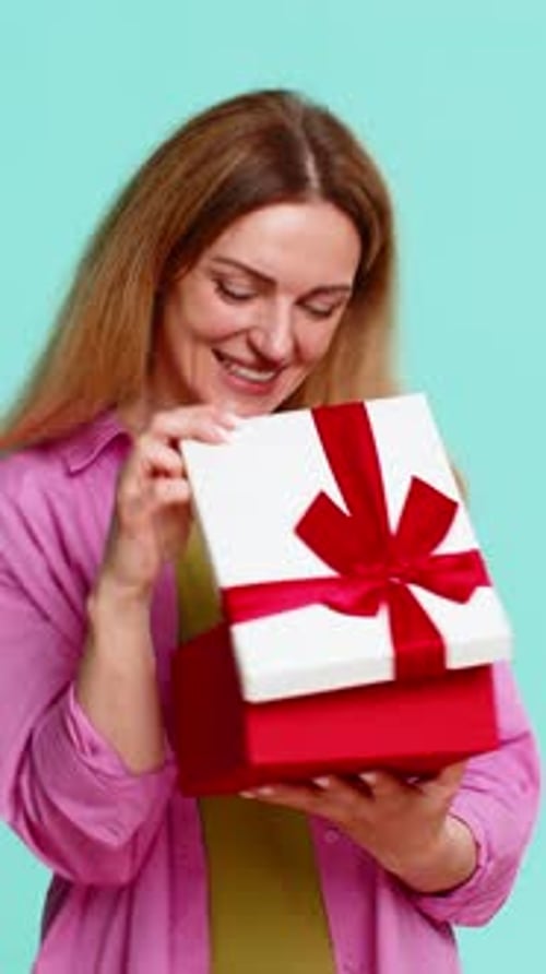 Woman Opening Gift Box with Excitement Showing Joy Surprise Celebration Moment with Cheerful Smile