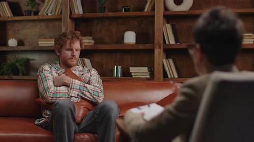 Man at Therapy Session Hugging a Pillow