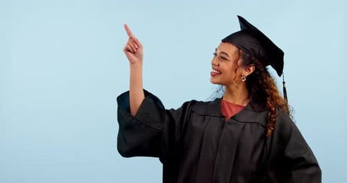 Happy woman, graduate and student pointing at studio news, university promotion