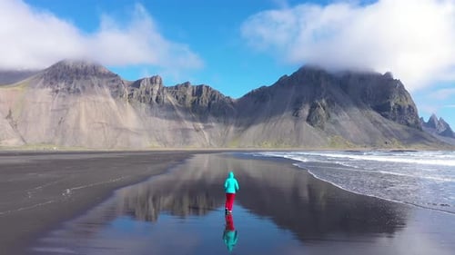 Slow Motion View of Woman Jogging on Atlantic Ocean Coast Iceland Aerial