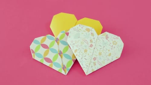 Origami Paper Hearts and Hexagon on Pink