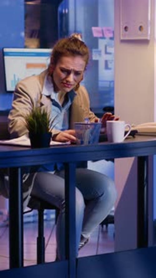 Businesswoman Working Late at Office Desk