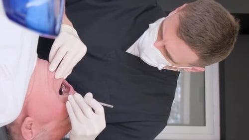 A Dentist Works with an Older Man Examining His Teeth in the Clinic the Concept of Dentistry