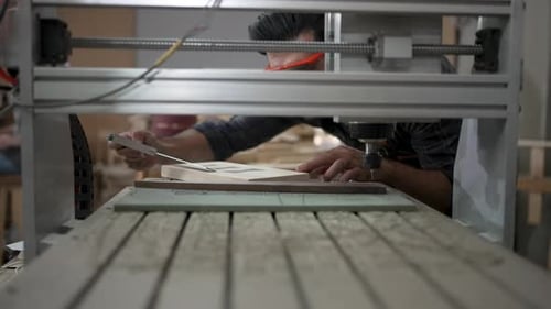 Carpenter is working at workshop.