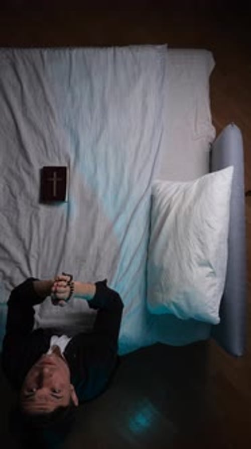 Young Man Praying With Rosary Beads