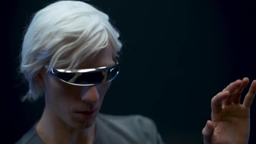 Man with futuristic glasses interacts with virtual interface