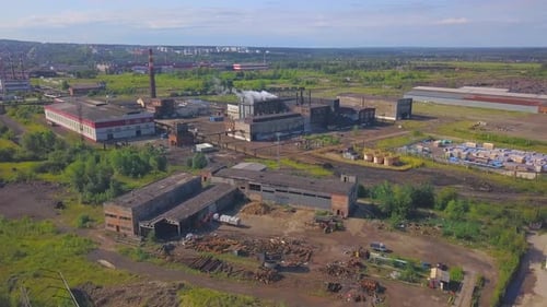 Industrial Plant Emitting Smoke From Large Chimney Near City