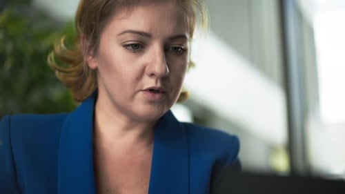 Work at Home Young Female Office Employee Fills Out Reports While Sitting at a Laptop in Room