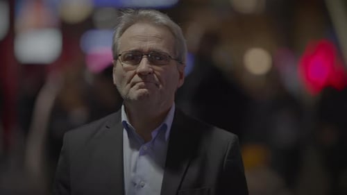 Mature Man Standing with Arms Crossed in City