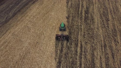 Green Tractor Plow Plowing Field Soil Harvest Digging Soil After Mowing Field