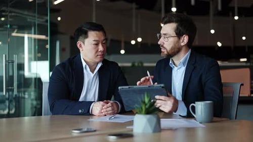 Businessmen Meeting in Modern Office with Tablet