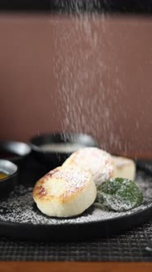 Someone will eat cheesecakes in a cafe. Close-up