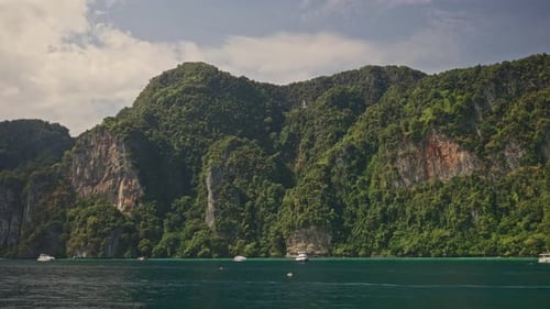 Serene Lake Scene with Boat Mountains and Cloudy Sky