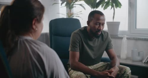 Back View of Female Psychologist Providing Therapy Session to Soldier