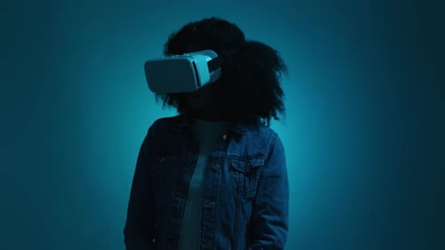 Woman Wearing VR Headset in Blue Studio