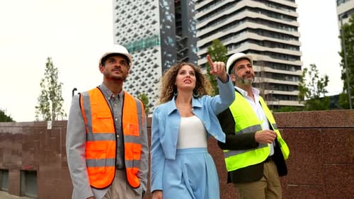 Professional Architects and Engineers Inspecting a Modern Building Site