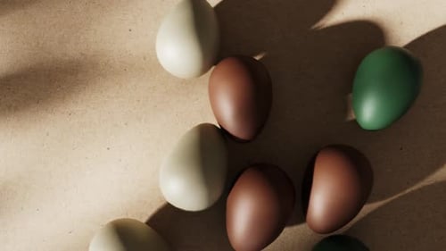 Easter eggs rolling on paper with Happy Spring text.