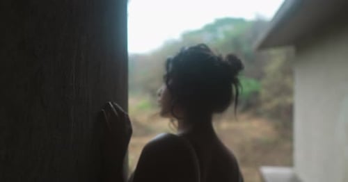 Young Woman at Window Looking at Trees