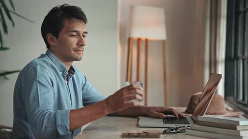 Business Man Working in Home Office and Typing on Keyboard of Laptop Computer