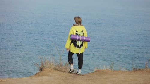 Rear View of a Male Tourist Delighting Sea View During Hiking on Mountain Trail