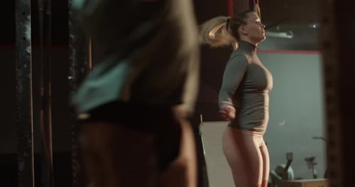 Unrecognizable Man and Woman Training in Gym