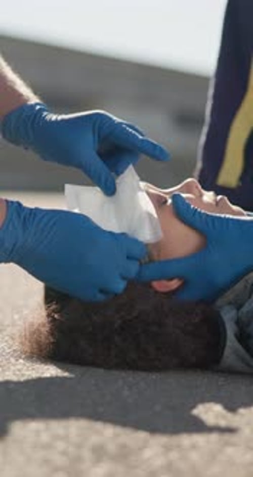 Head injury, bandage on woman and paramedic on street for emergency, accident or first aid