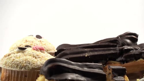 Close-up of Assorted Sweet Chocolate Eclairs and Cupcakes