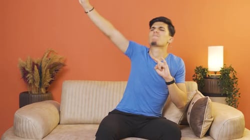 Man doing rocker sign and dancing.