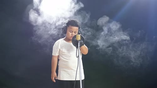 Child Singer Performing in Recording Studio with Microphone