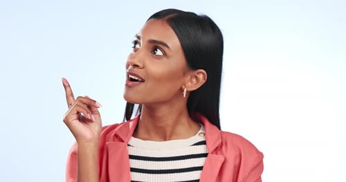 Woman, thinking and pointing in portrait with ideas, inspiration and solution on blue background