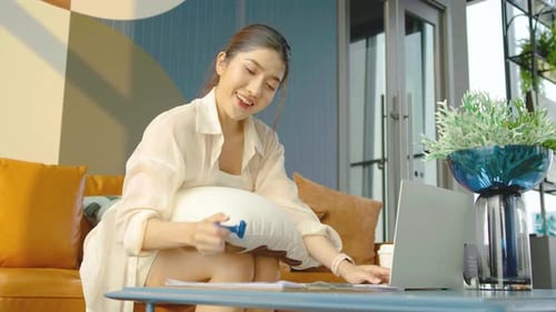 Young Woman Works on Laptop at Home