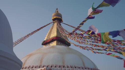 Religious Prayer Flags At Boudhanath Stupa Flying In The Air Against The Blue Sky In Kathmandu, Nepa