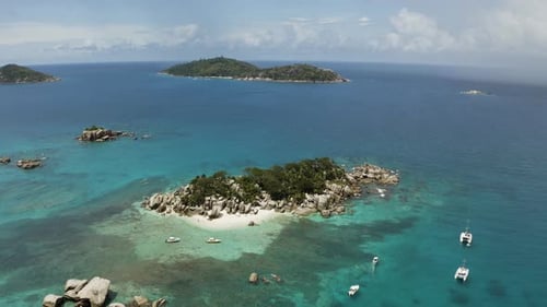 Aerial: Flying around Lonely Island with White Sand Beach and Palms, Seychelles