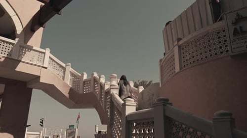 Woman Walking Up Stairs in Mutrah Souq, Oman