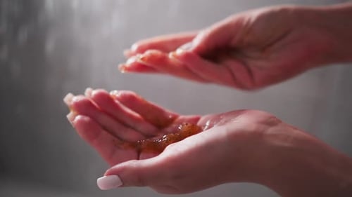 Woman Holding Body Scrub in Hands