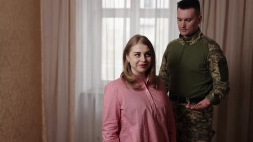 Soldier Returns Home to Embrace Wife Indoors