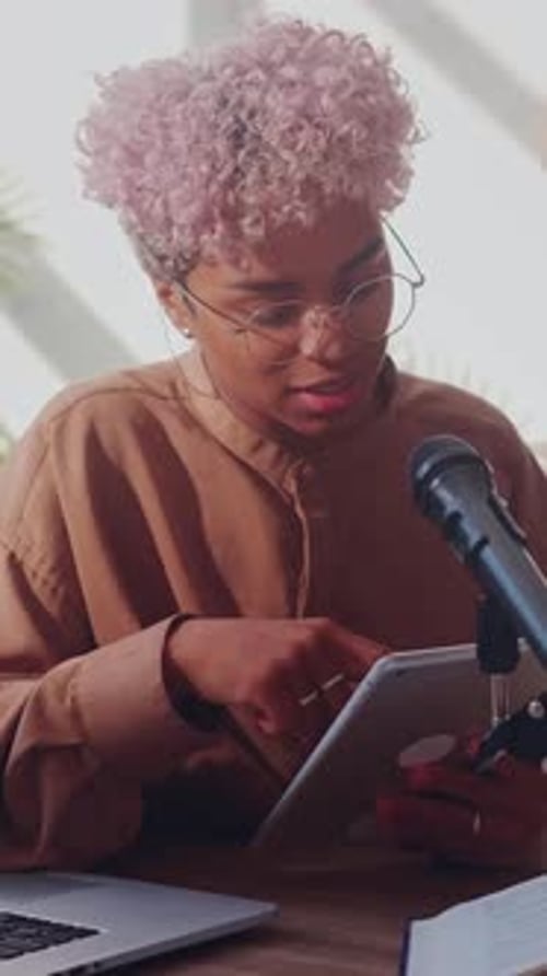 Young African American Teacher Uses a Tablet to Manage Her Online Lesson