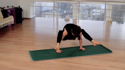 Slim Woman Standing in Yoga Pose Keeping Balance Practicing Meditation at Fitness Studio Barefoot