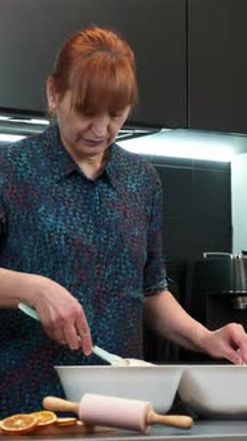 Woman Preparing Food in a Modern Kitchen