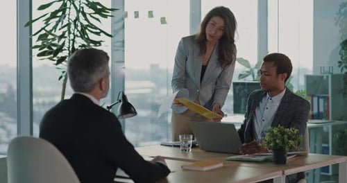 Business team collaborating at desk in modern office
