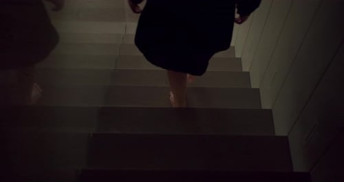 Women Walking Down Modern Interior Staircase