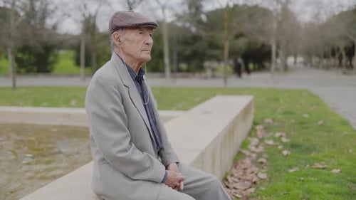 Grandfather Enjoying a Peaceful Moment in a Park