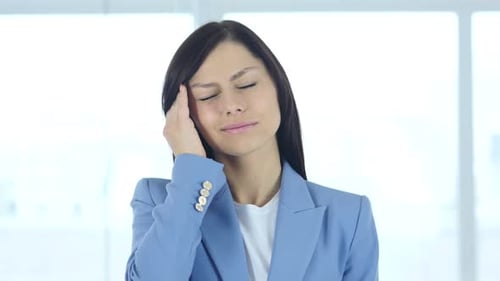 Headache Upset Tense Young Female in Office