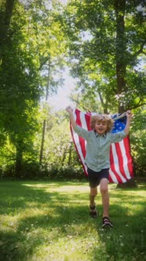 Boy Runs with American Flag in Sunny Park