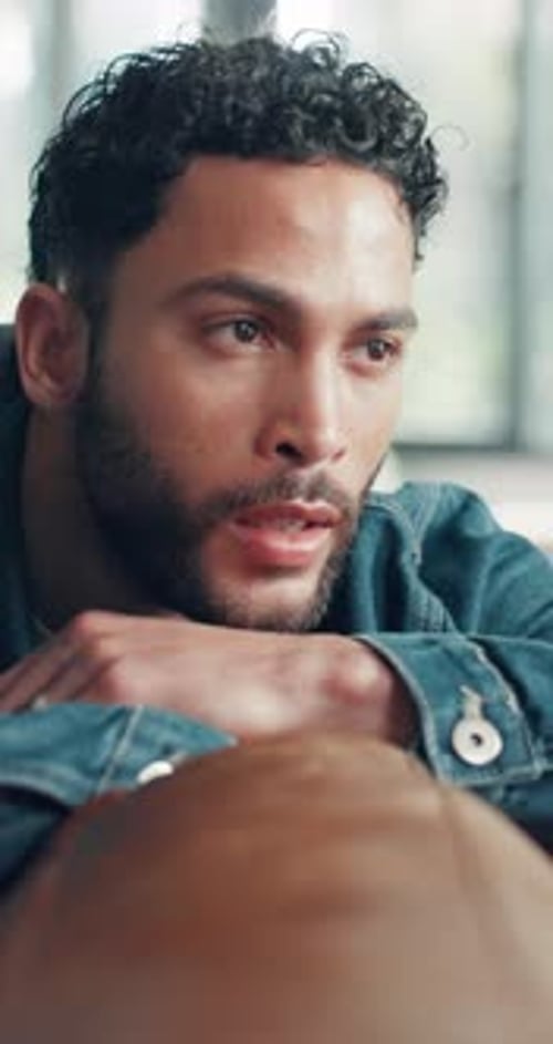 Man Resting Chin on Hands Looking Thoughtful