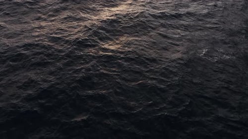 Nightfall Over Sea with Glowing Gentle Waves and Distant Shadows